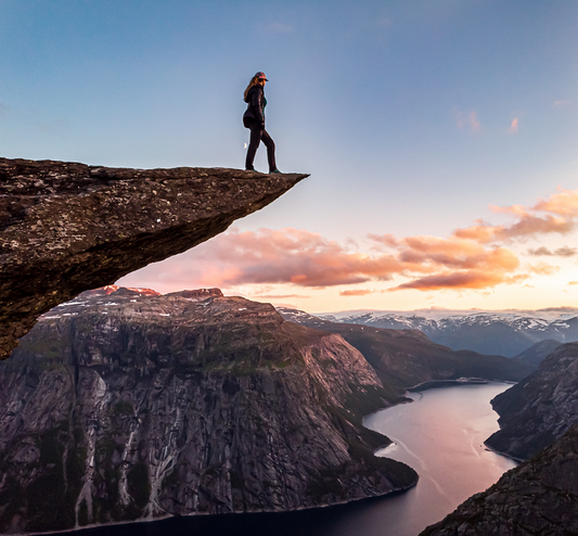 girl standing on a rock cliff edge